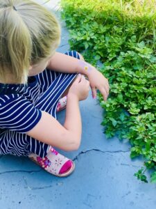 Ella places a flower on her bracelet