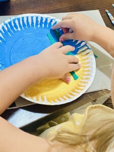 Ella adds seaweed to the ocean craft