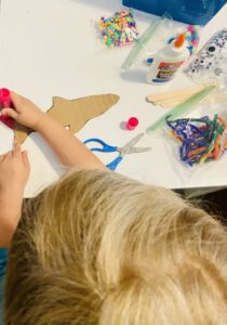 Ella decorating her shark craft