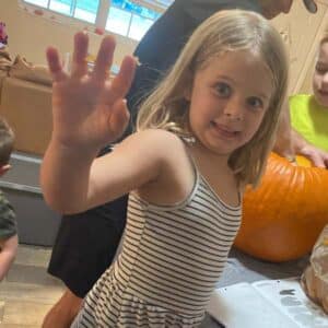 Ella having fun carving a pumpkin