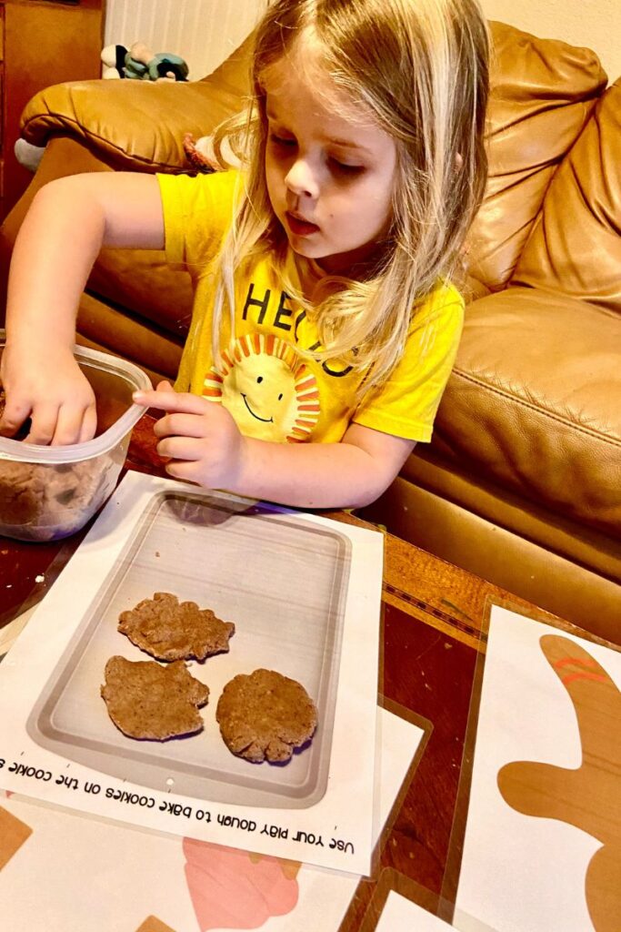 child making cookies with play dough