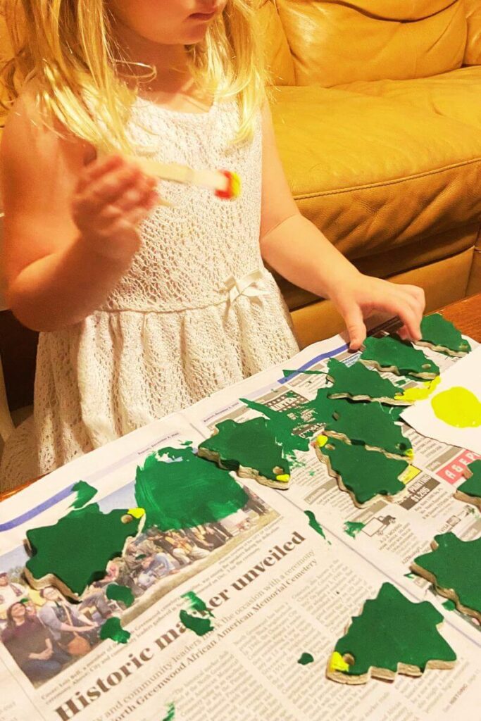 ella painting salt dough christmas trees