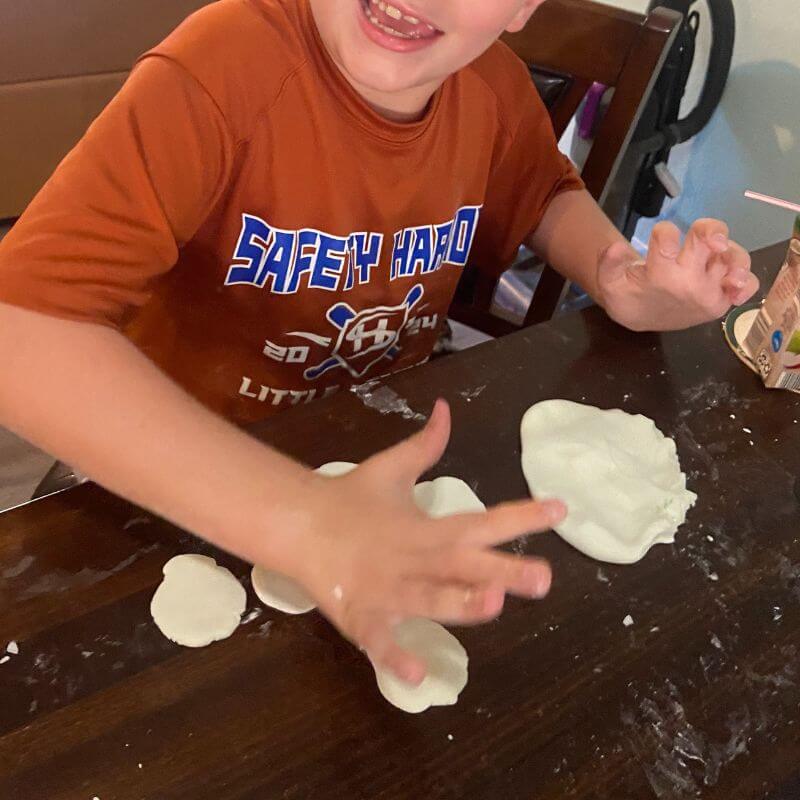 child having fun with cloud dough