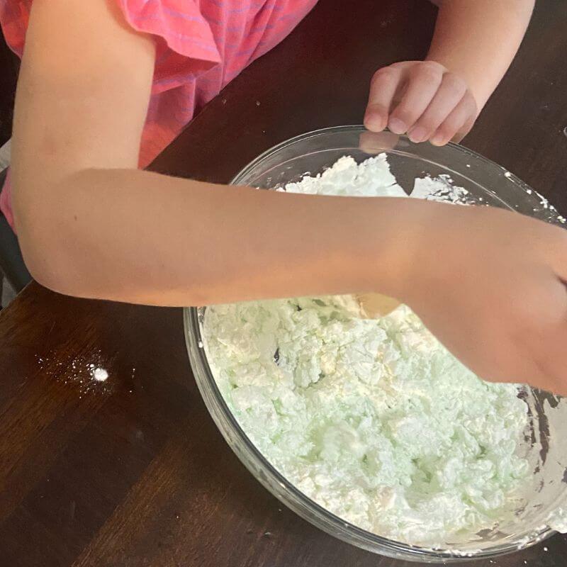 mixing ingredients to make cloud dough