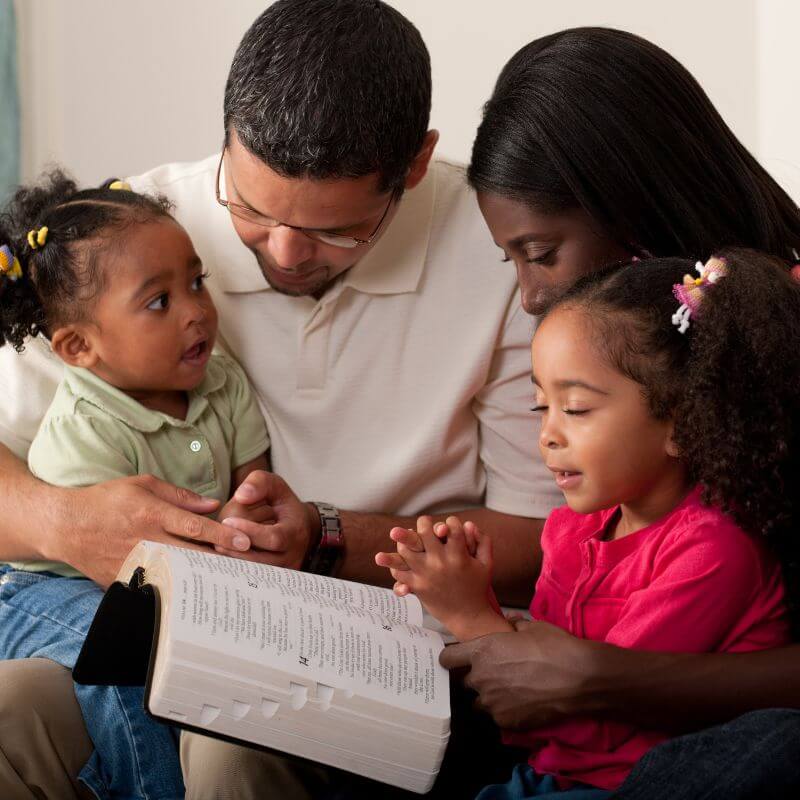 family reading the Bible together during family prayer time