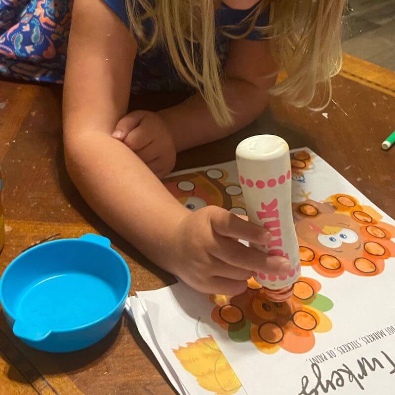 child using dot markers