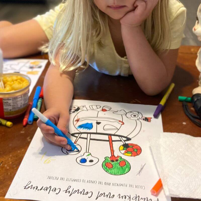 child coloring with markers