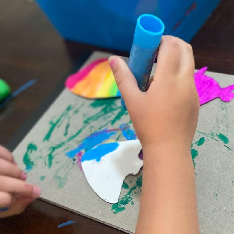 child using paint sticks