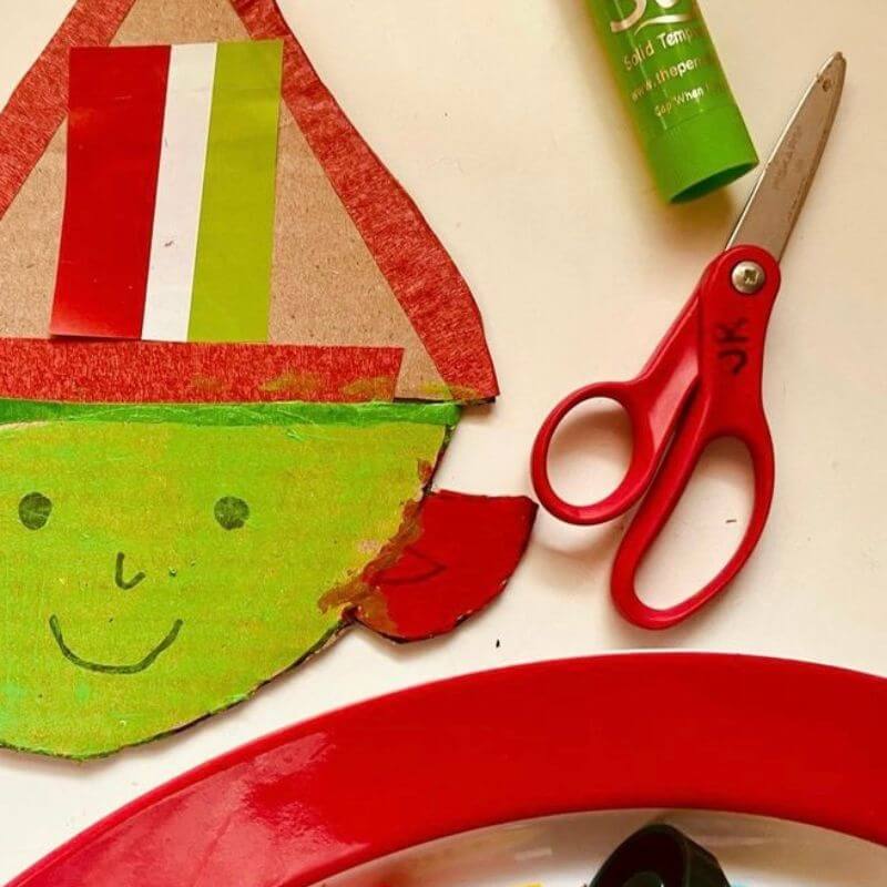 scissors and a child's elf craft