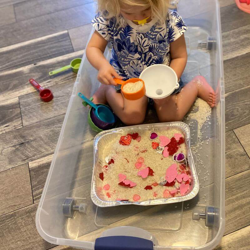 child playing with rice sensory bin