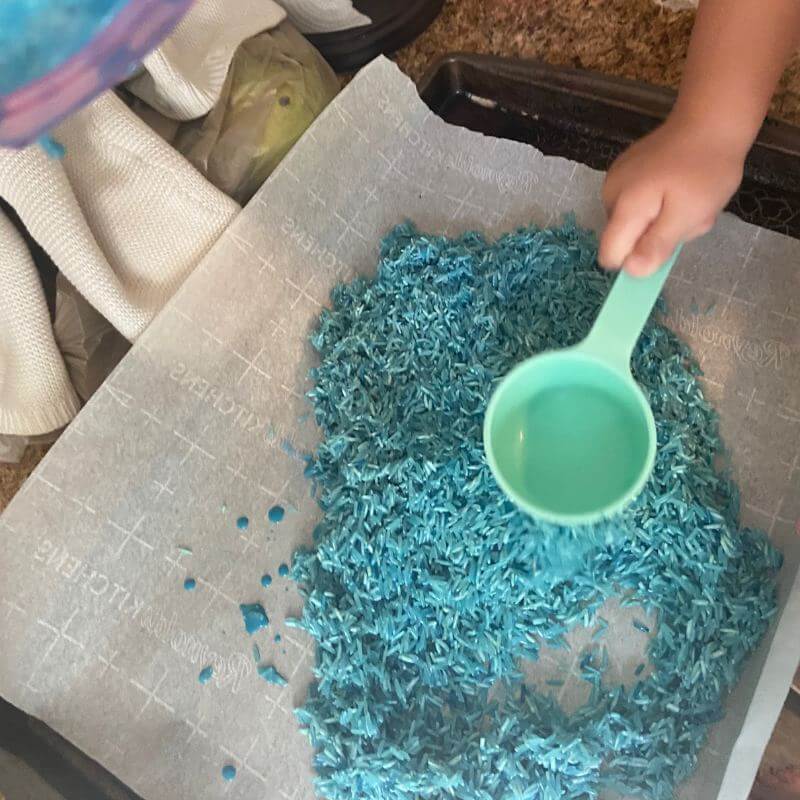 rice dyed blue and spread out on a baking sheet