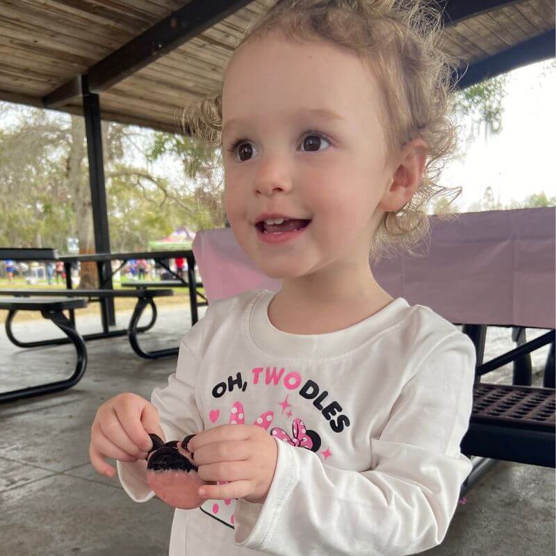 ruthie smiling wearing her "oh toodles" shirt