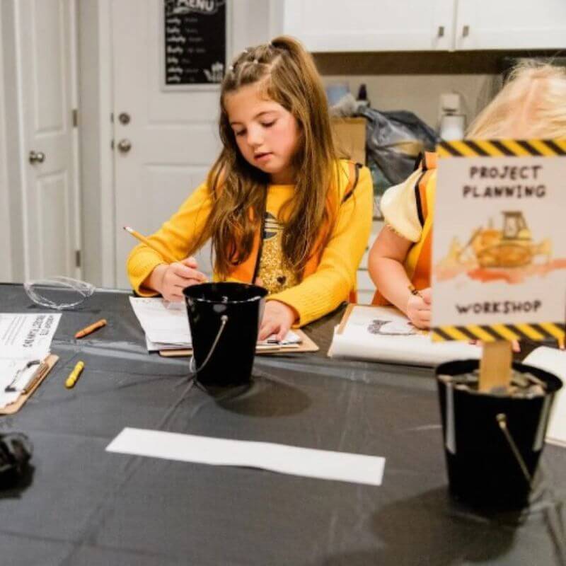 girl at construction themed birthday party