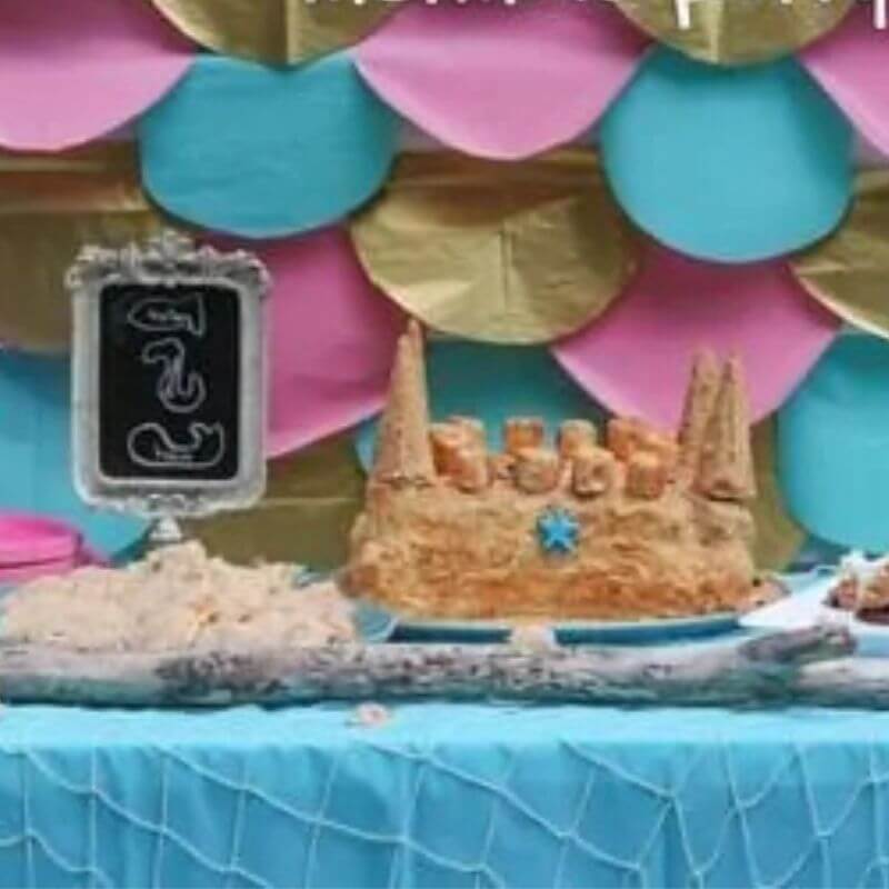 sand castle cake and mermaid party decor