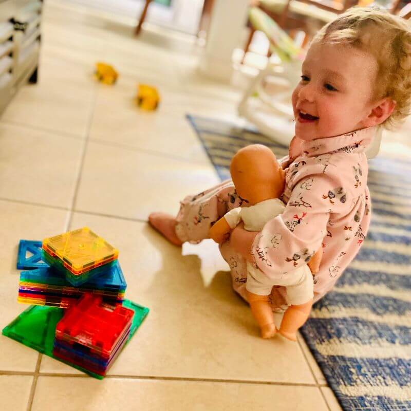 toddler playing with magnetic tiles