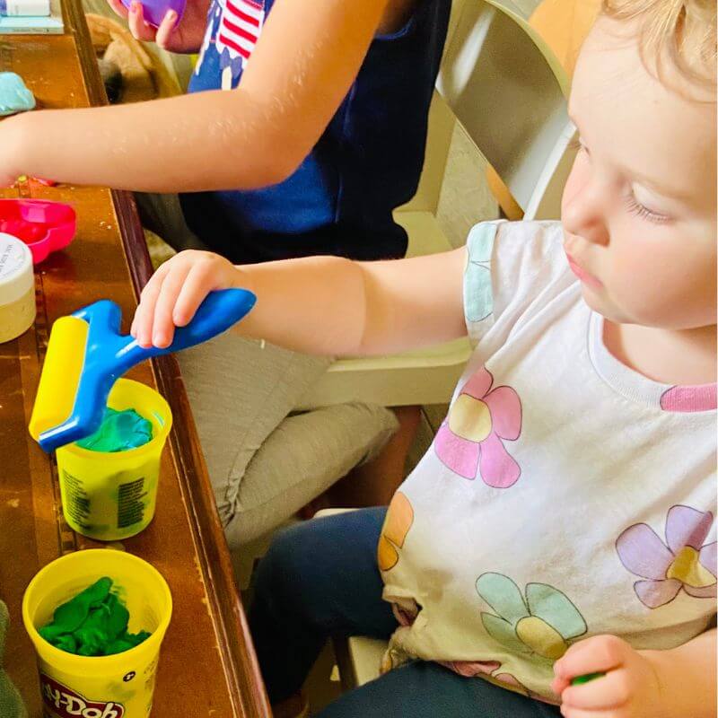 two girls playing with play dough