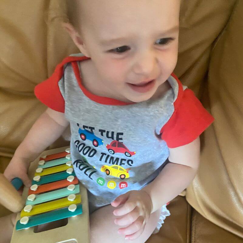 toddler holding an xylophone