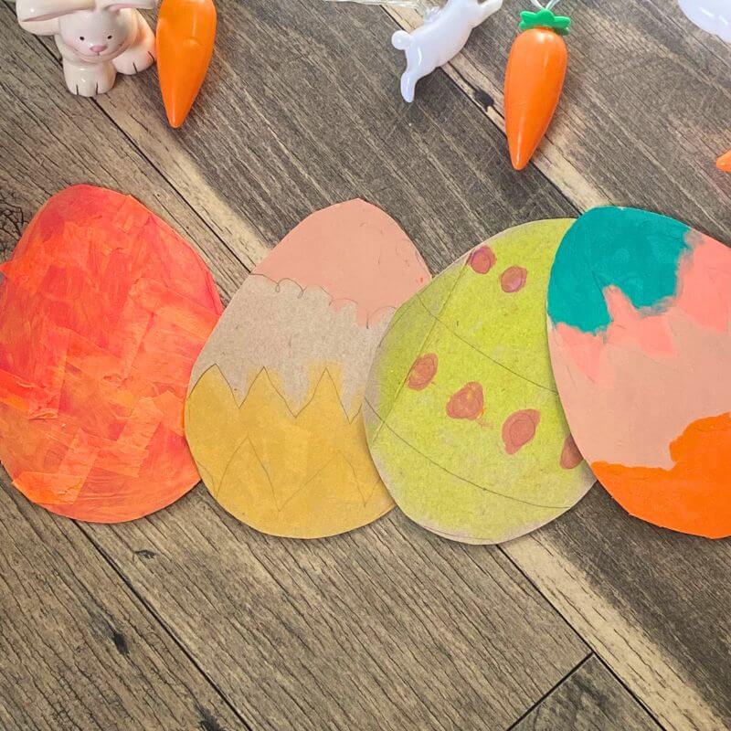 cardboard easter eggs decorated with tempera paint sticks